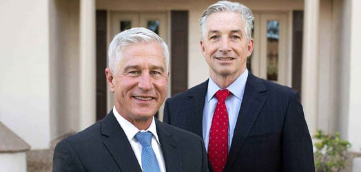 Shawn Cunningham and Frank Powers in front of their law office building