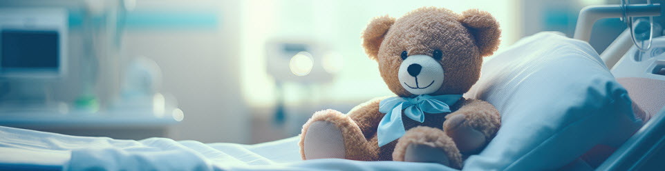 stuffed teddy bear in a child's hospital bed