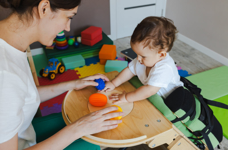young toddler in rehabilitation session with a physical therapist